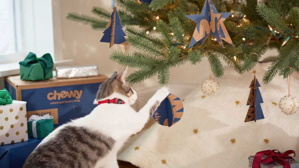 Photo of a cat batting at diy Christmas tree ornaments made from Chewy boxes