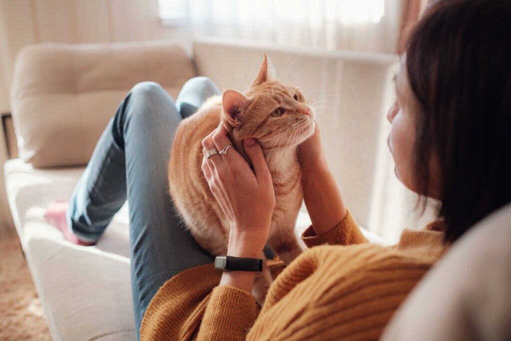 woman-sitting-on-couch-with-cat