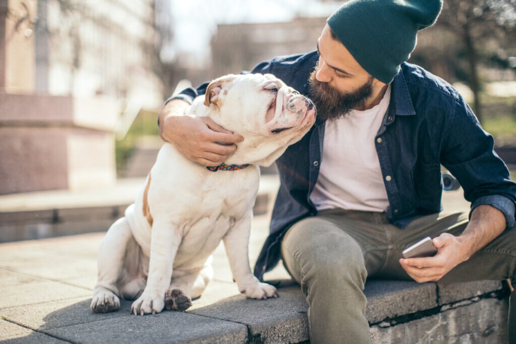 man-sitting-with-bulldog-on-step