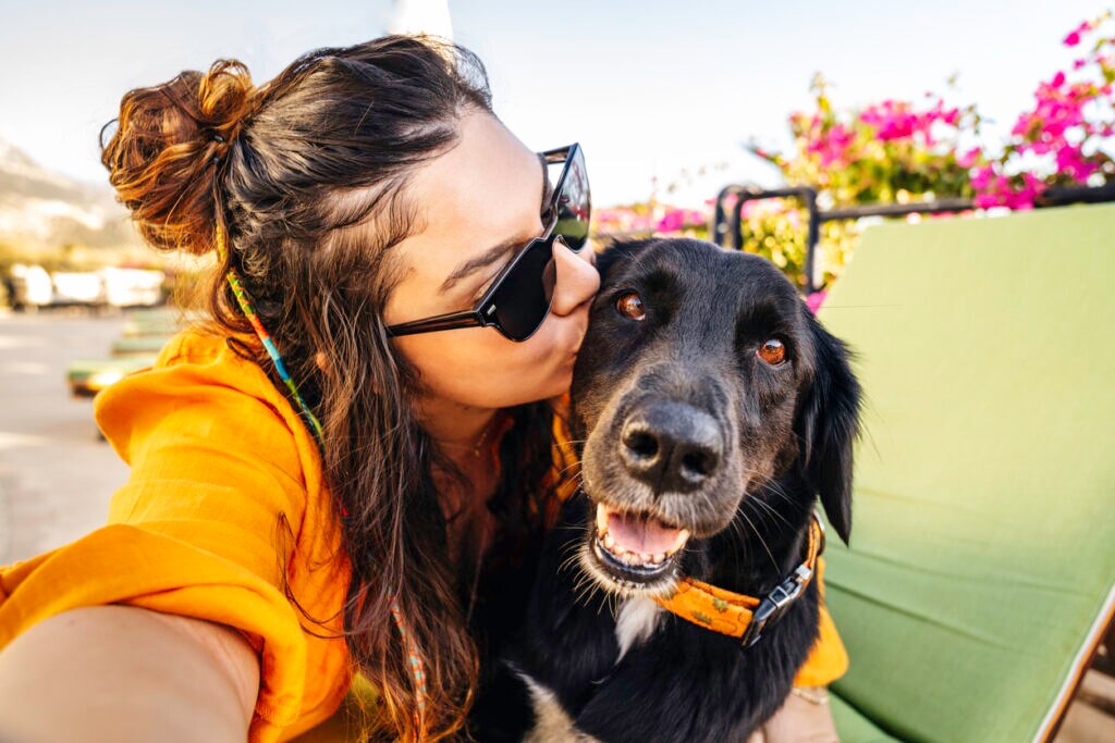 woman takes selfie of herself and black lab mix