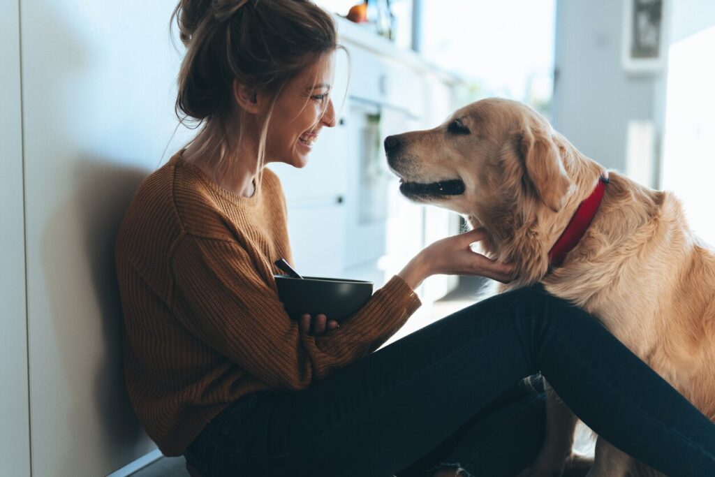 woman-sitting-on-kitchen-floor-with-lab