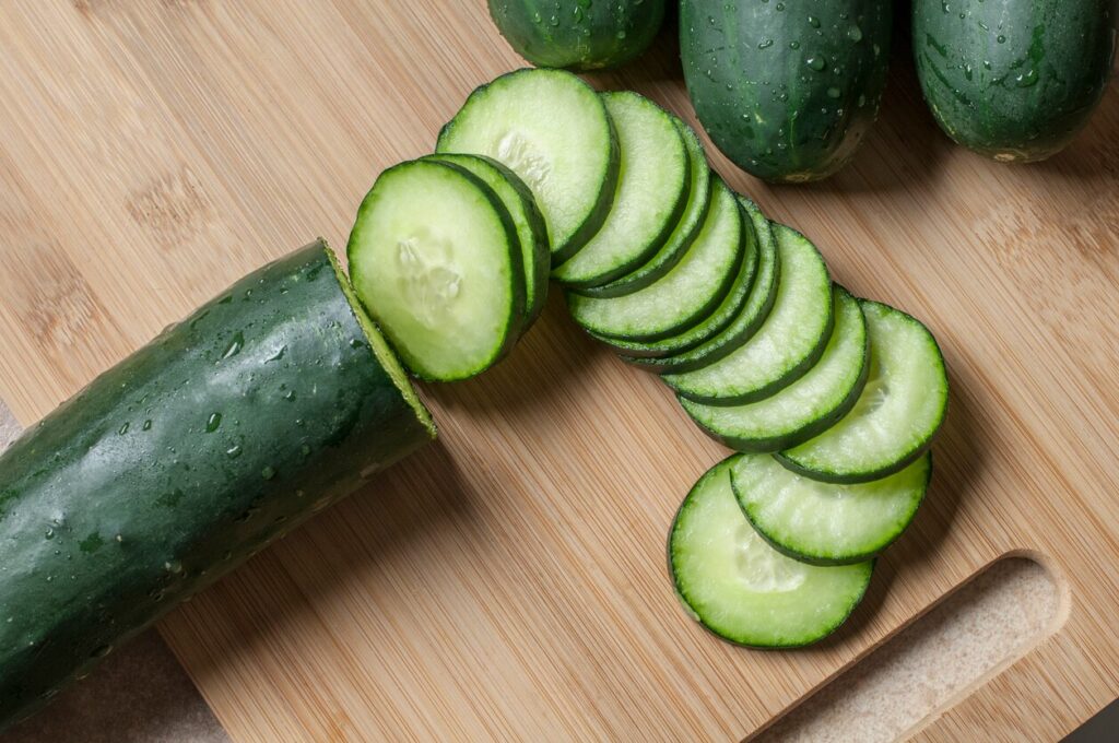 cucumber with cut slices on a cutting board