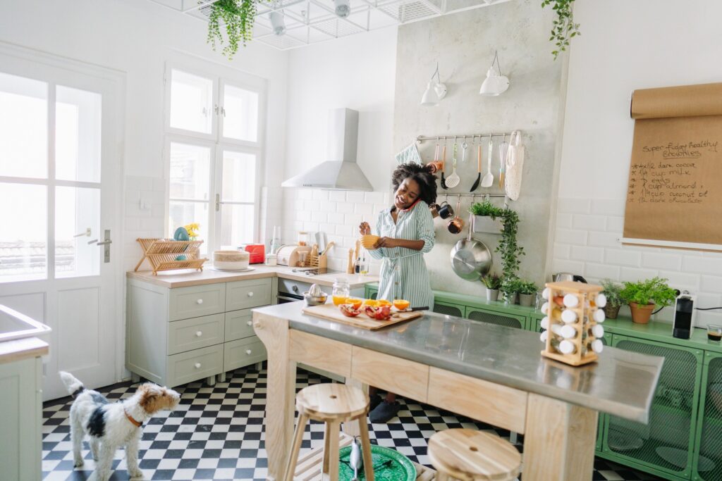 woman preparing food with a pomegranate in her kitchen