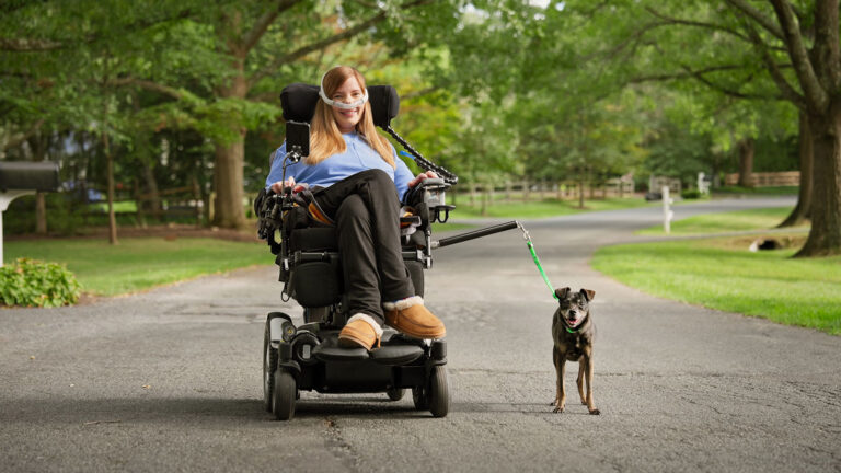 Brooke Eby and her dog Dray test out their new adaptive leash