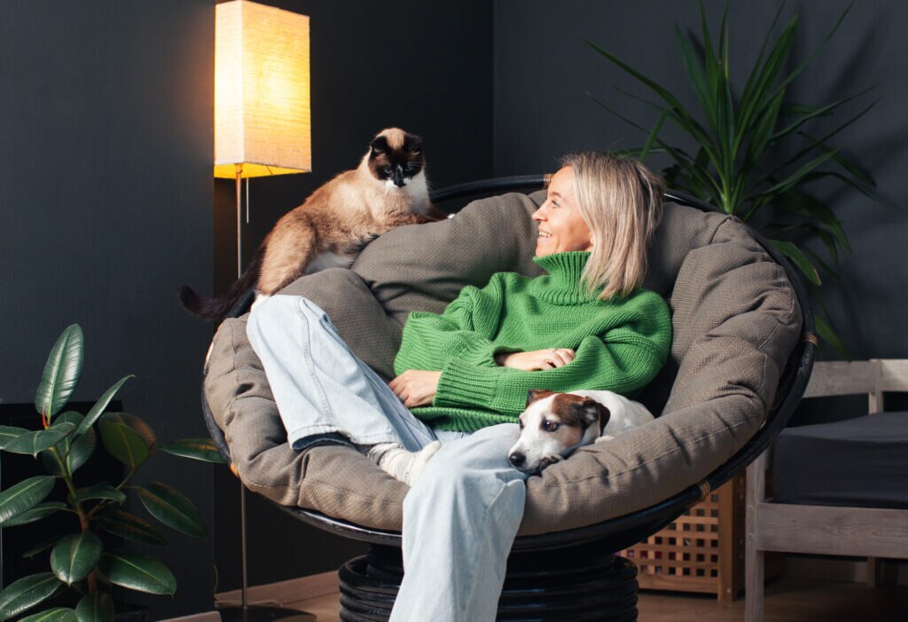 how much is pet insurance; woman relaxing with her pets