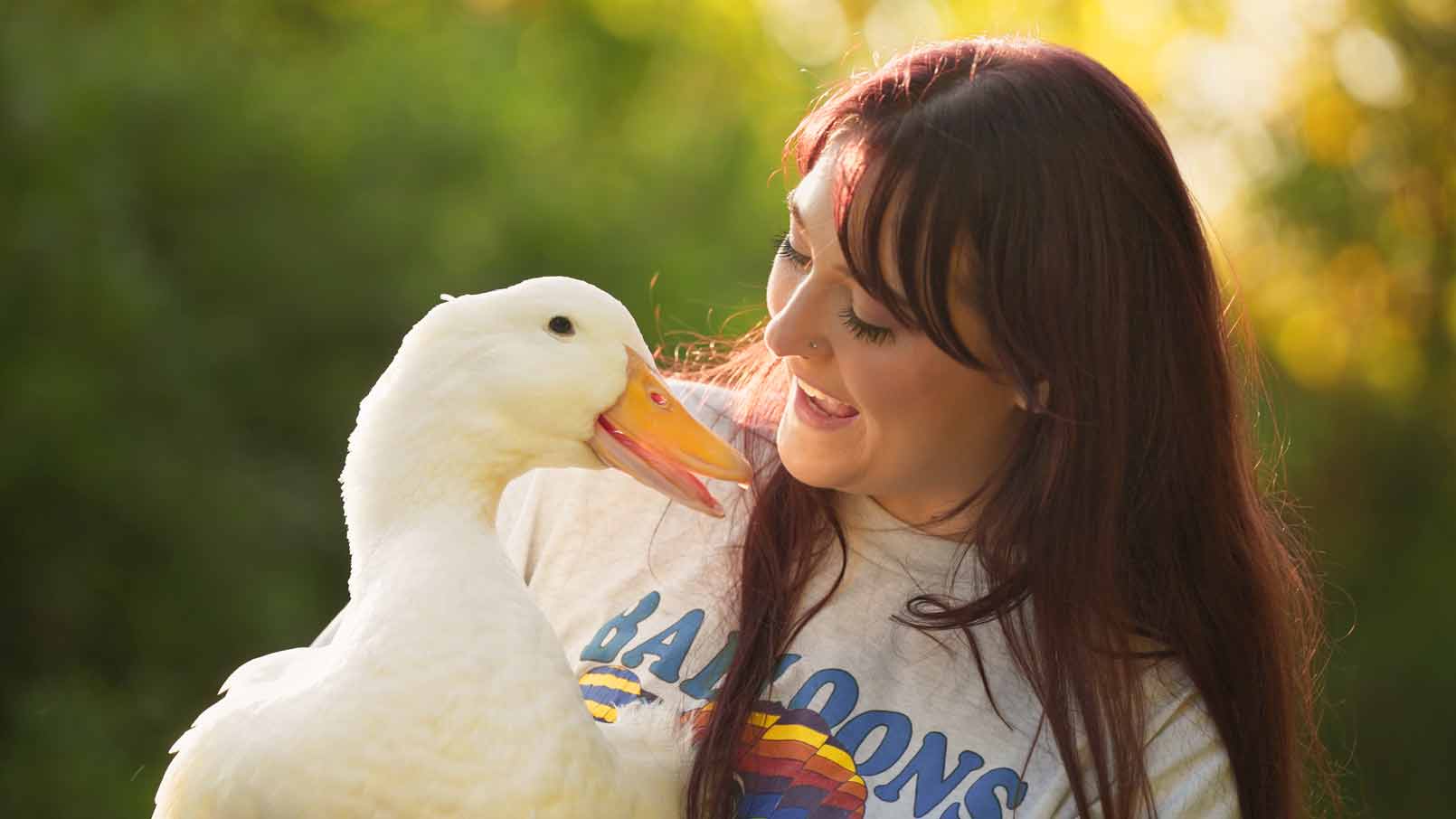 Fern the duck and her pet parent Aspen smiling at each other