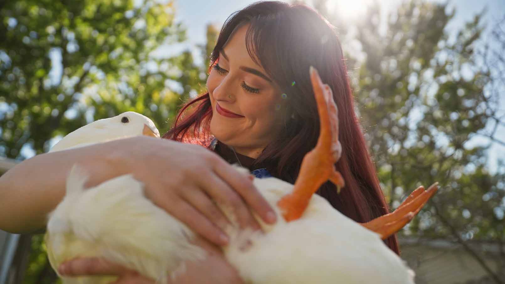 Aspen cradles Fern the duck in her arms