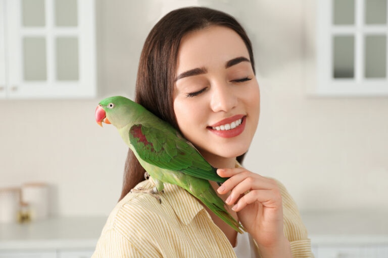 Woman with bird perched on her shoulder