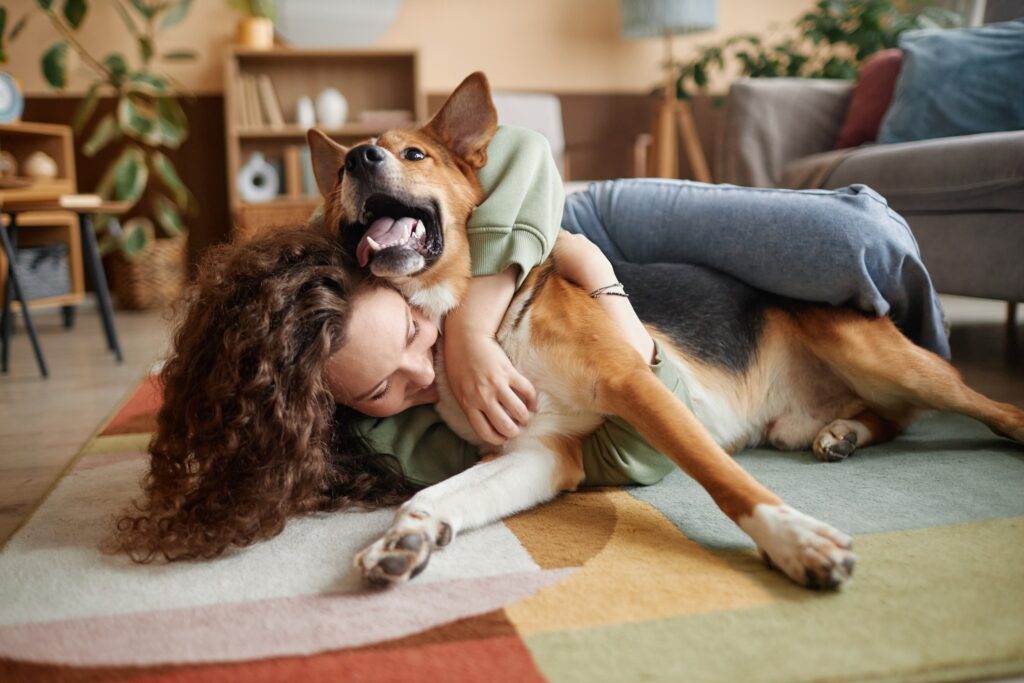 how pets impact our mental health; a pet parent hugs their dog.