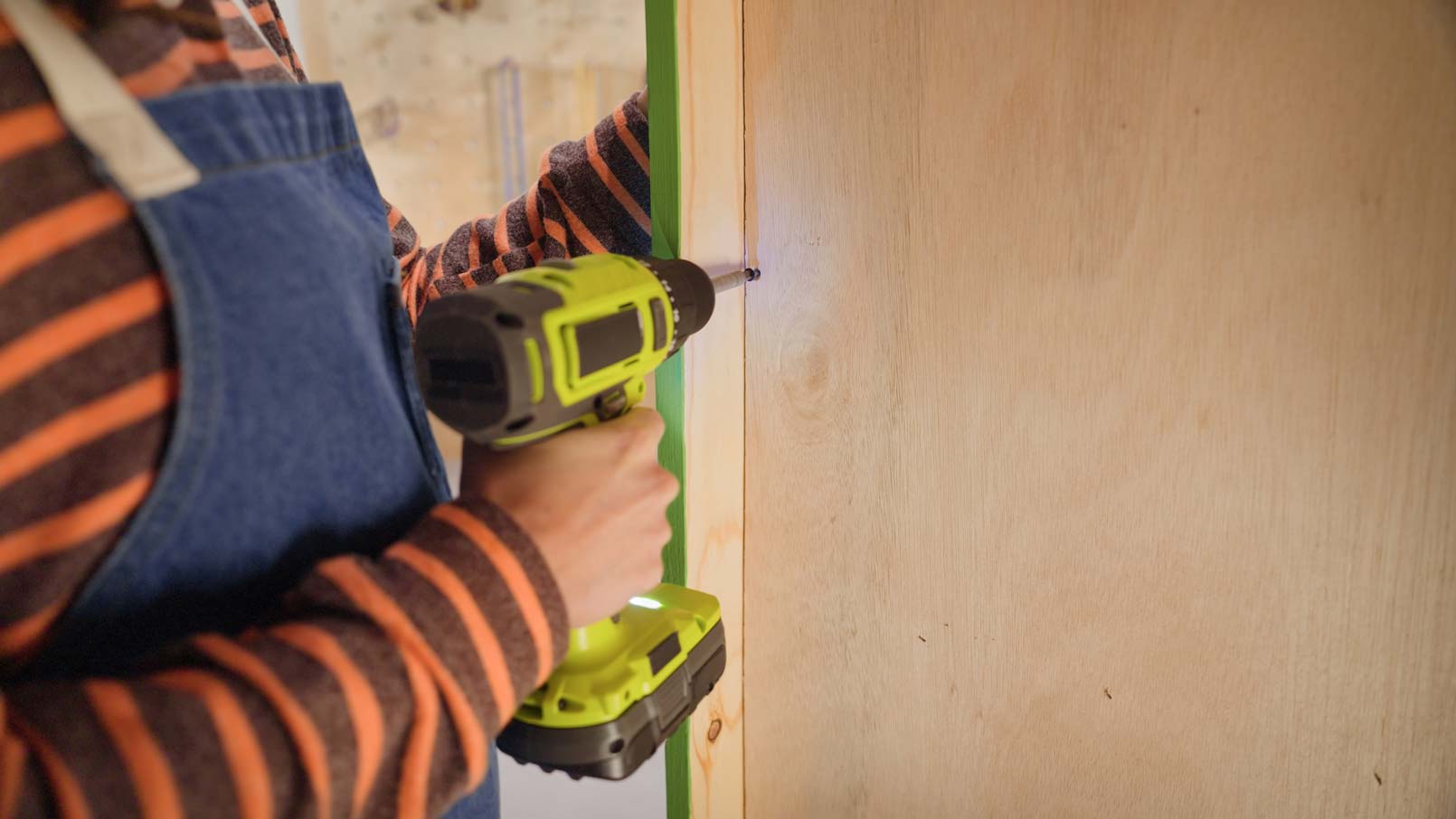 a woman building a chicken coop