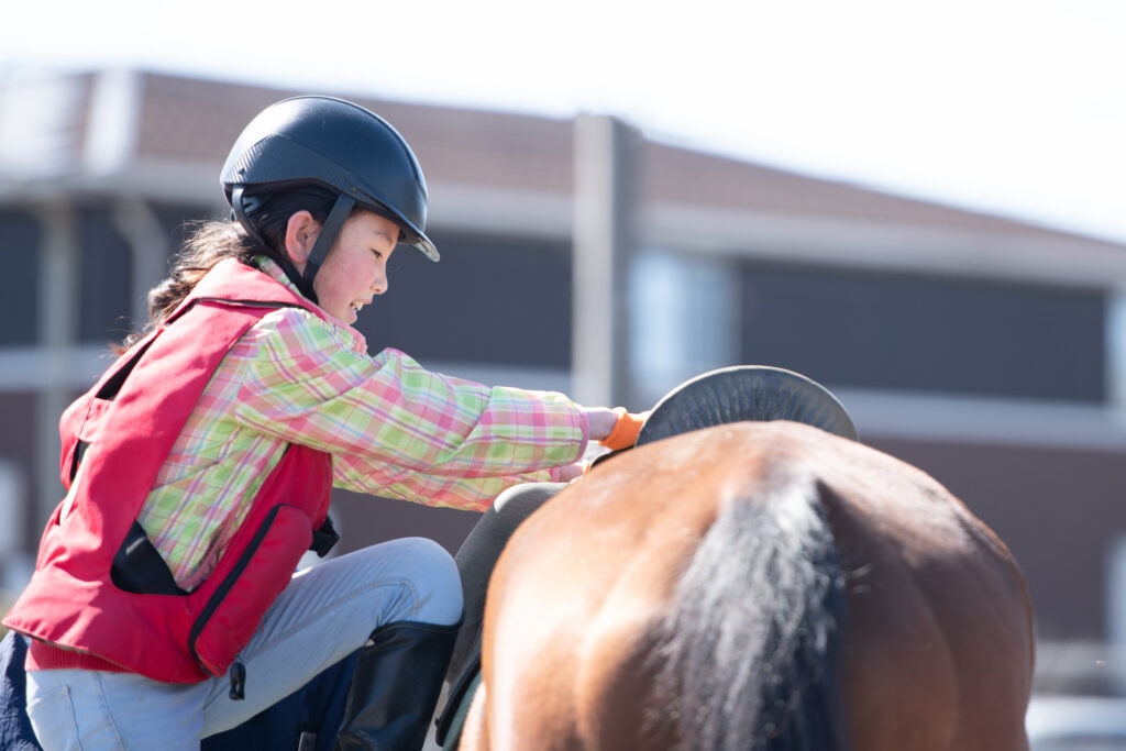 Girl mounting a horse